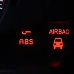 Car dashboard with various warning lights illuminated