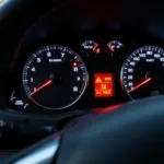 Close-up of a car dashboard illuminated with engine warning lights