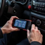 Mechanic using a car diagnostic scanner on a vehicle