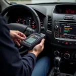 Mechanic using a car diagnostic scanner