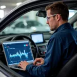 Car diagnostic technician in Peterborough analyzing diagnostic data on a laptop