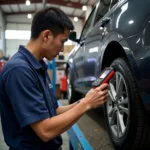 Mechanic Using a Car Diagnostic Tool to Troubleshoot a Vehicle in the Philippines