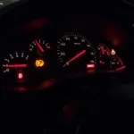 Car dashboard with warning lights illuminated