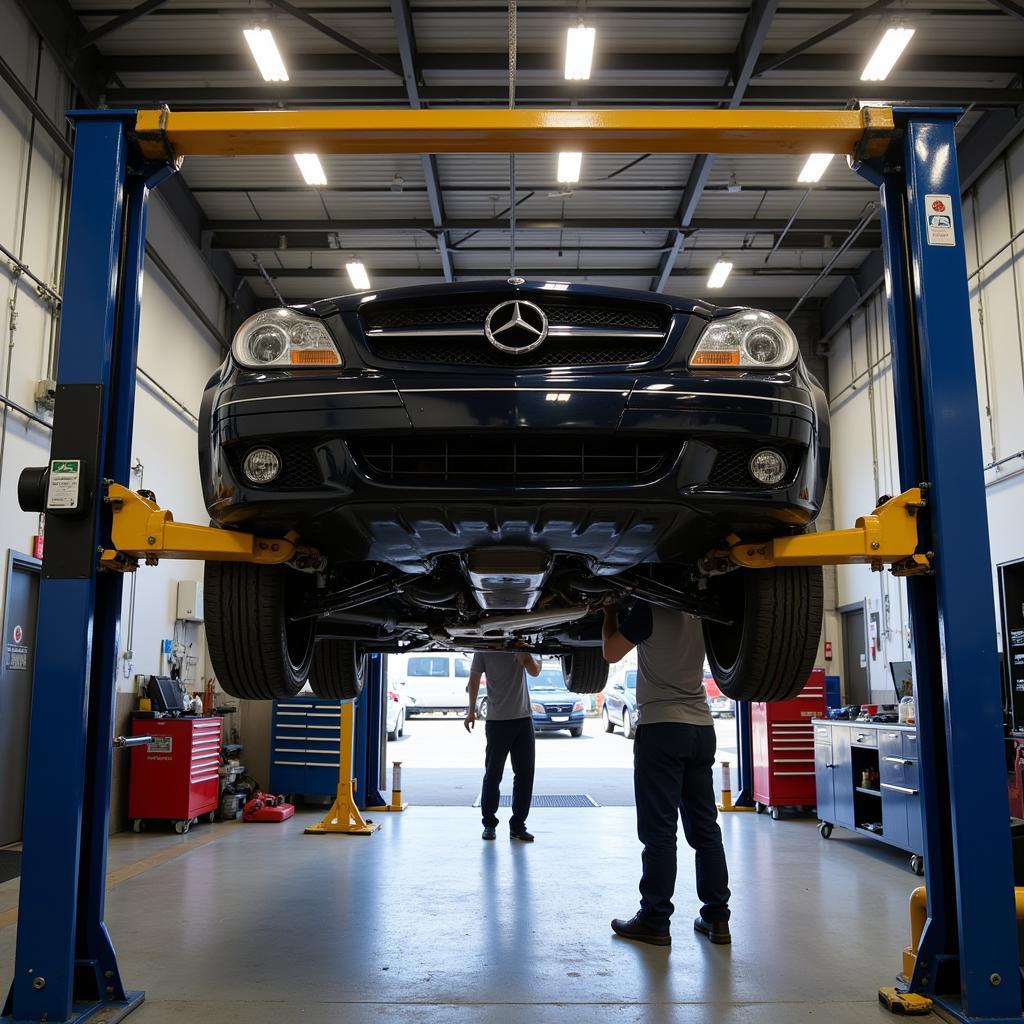 Car on a lift for a mechanical inspection.