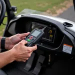 Mechanic using a club car controller diagnostic tool on a golf cart