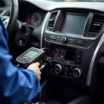 Mechanic using a diagnostic scanner car