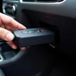 Car diagnostics checker connected to a car's OBD port