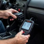 Mechanic using a diagnostic scan tool on a car engine