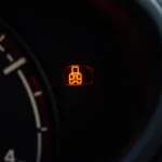 Engine warning light illuminated on a car dashboard