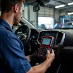 Mechanic using a car diagnostic tool