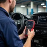 Mechanic connecting a car diagnostic tool to a vehicle