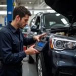 Mechanic using a remote car diagnostic tool