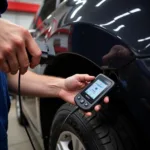 Mechanic using a Streetwize car diagnostic tool