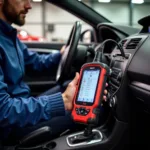 Tech 2 diagnostic tool connected to car OBD-II port