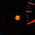 Car dashboard showing transmission warning light