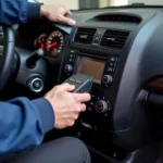 Mechanic using diagnostic equipment on a used car