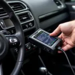 VW Golf engine diagnostic tool being used by a mechanic.