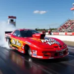 2000 Firebird Funny Car Mac Tools racing down the drag strip