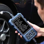 Mechanic using a best car scan tool to diagnose a vehicle.