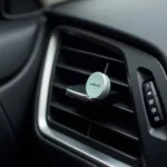 Car air vent with an attached fragrance clip.