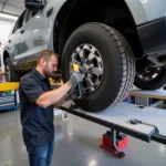 Mechanic Using a Car Alignment Tool Set