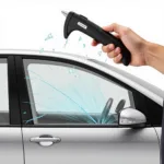 Car escape tool being used to break a car window in an emergency situation