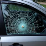 Car window smashed by a car hammer theft tool