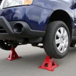 Car Safely Lifted with Jack Stands for Tire Change