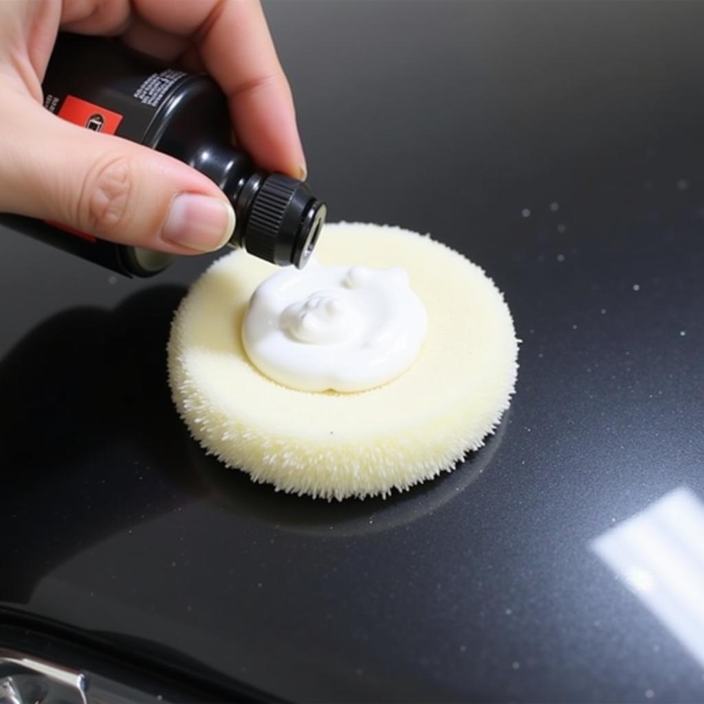 Applying car polishing compound to restore car paint