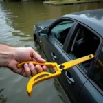 Car Submerged in Water, Escape Tool in Hand