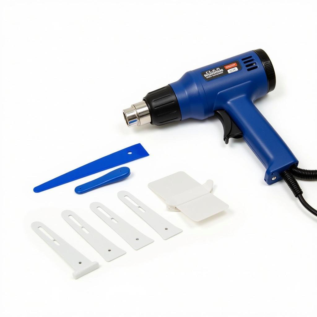 Car vinyl removal tools kit showing heat gun, plastic razor blades, and scraper