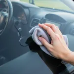 Cleaning inside car windshield with a microfiber cloth