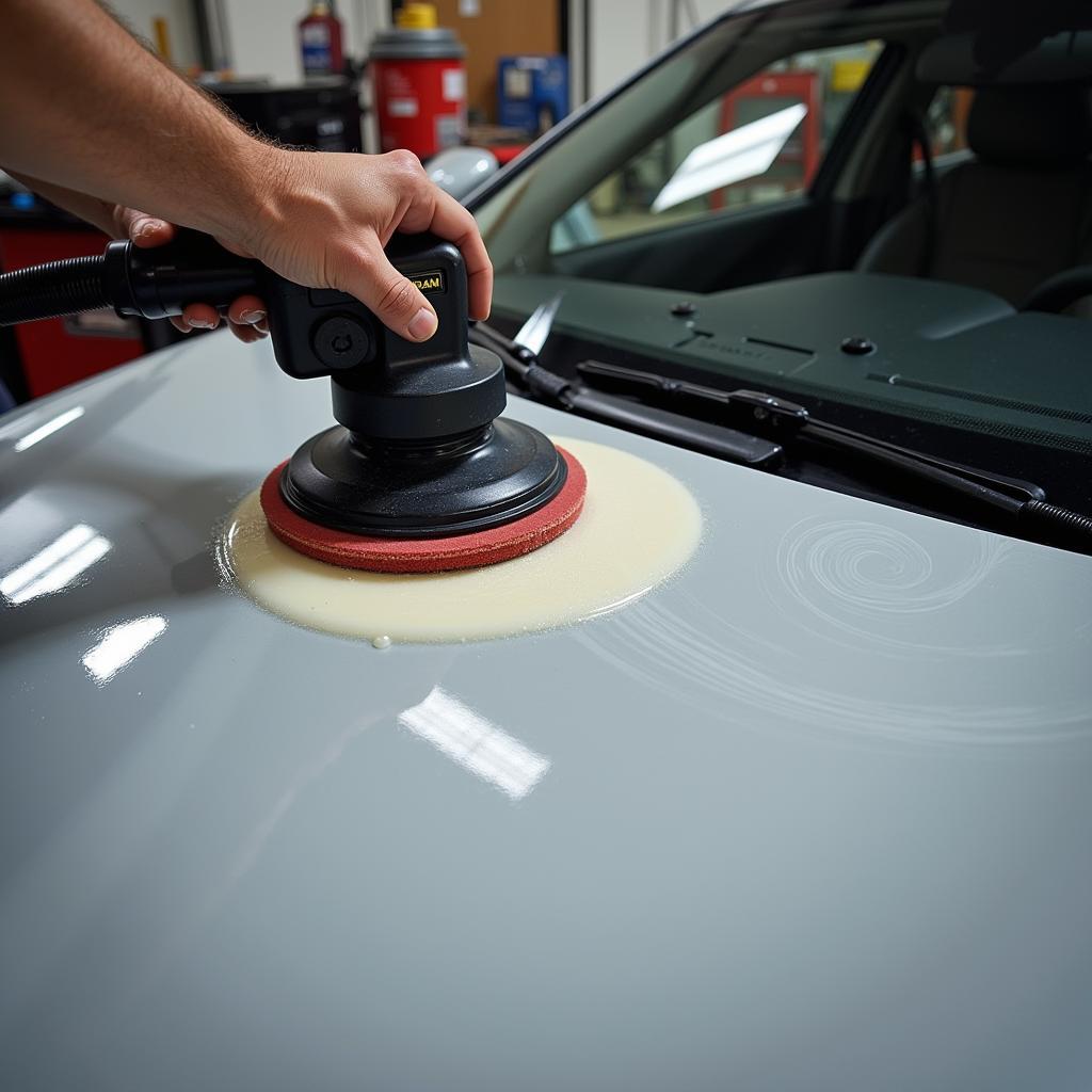 Dual-action polisher in action restoring car paint