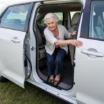 Elderly person using a car handle to exit vehicle