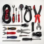 Essential car travel tool kit items: Jumper cables, tire pressure gauge, flashlight and essential tools.