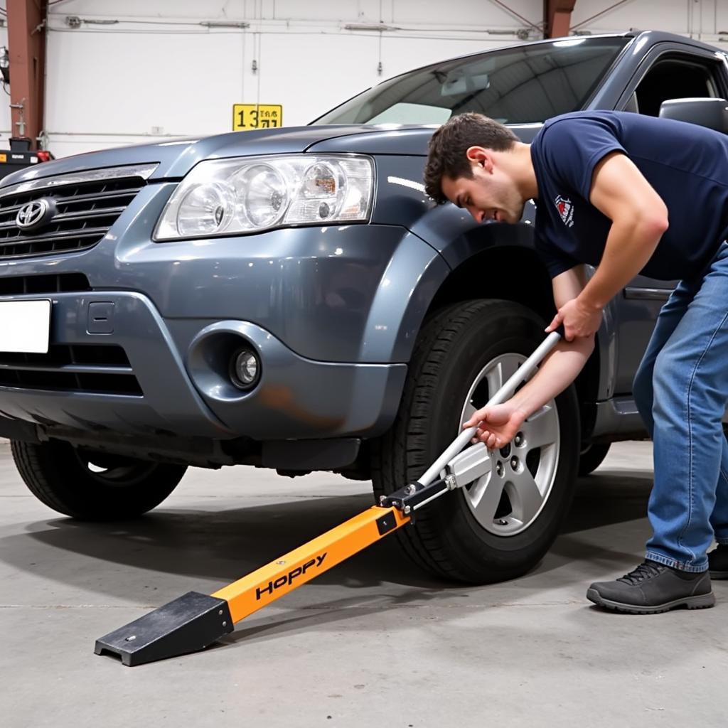 Hoppy car push tool lifting a car's front tire for easy maneuvering in a tight garage space.