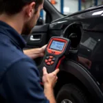 Mechanic Using Diagnostic Scanner on a Car