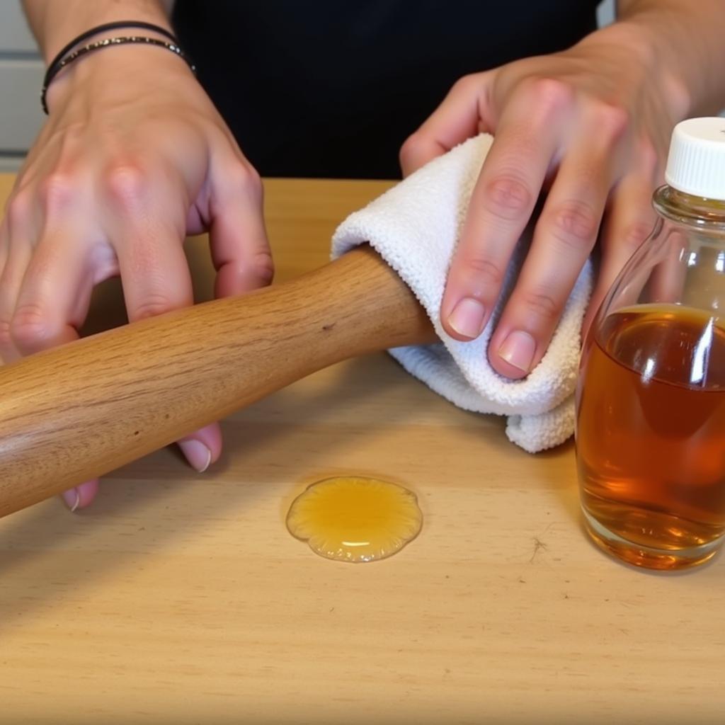 Applying jojoba oil to a wooden tool handle