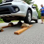 Lifting a car with rocks and wood for a tire change