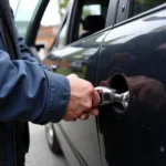 Locksmith using specialized tools to open a car door.