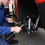 Mechanic Adjusting Wheel Alignment with Specialized Tools