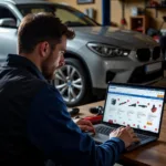 Mechanic Checking Car Tools Online on a Laptop