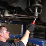 Mechanic using borrowed tools for a car repair