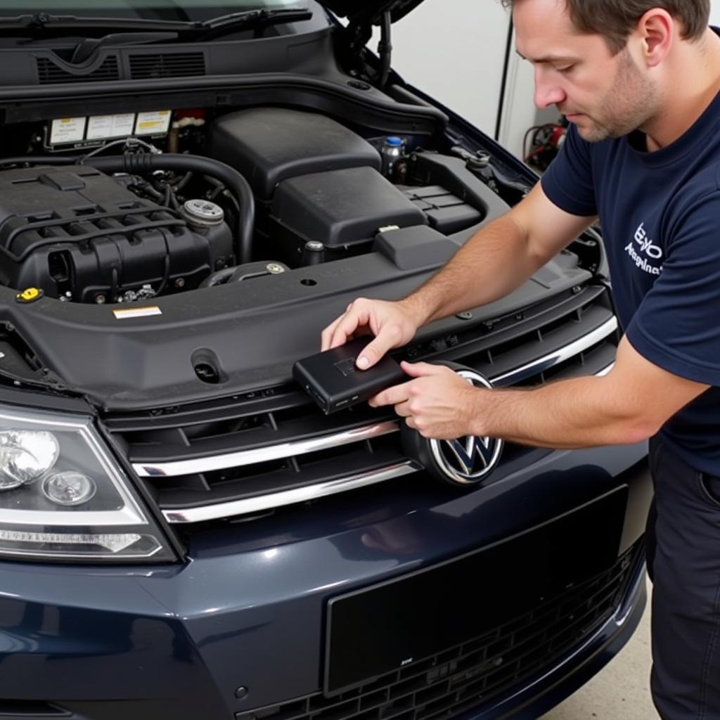 A mechanic using an OBD-II scanner on a car.