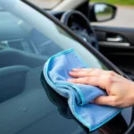 Microfiber Cloth Cleaning Inside Car Windshield