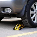 Mini Scissor Jack in Use on a Small Spaces Car