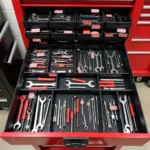 A well-organized toolbox with labeled compartments containing various sprint car tools, promoting efficiency and easy access.