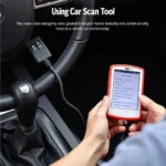 Person Using Car Scan Tool to Diagnose Car Problem