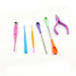 A set of colorful plastic nail care tools including pushers, clippers, and files.