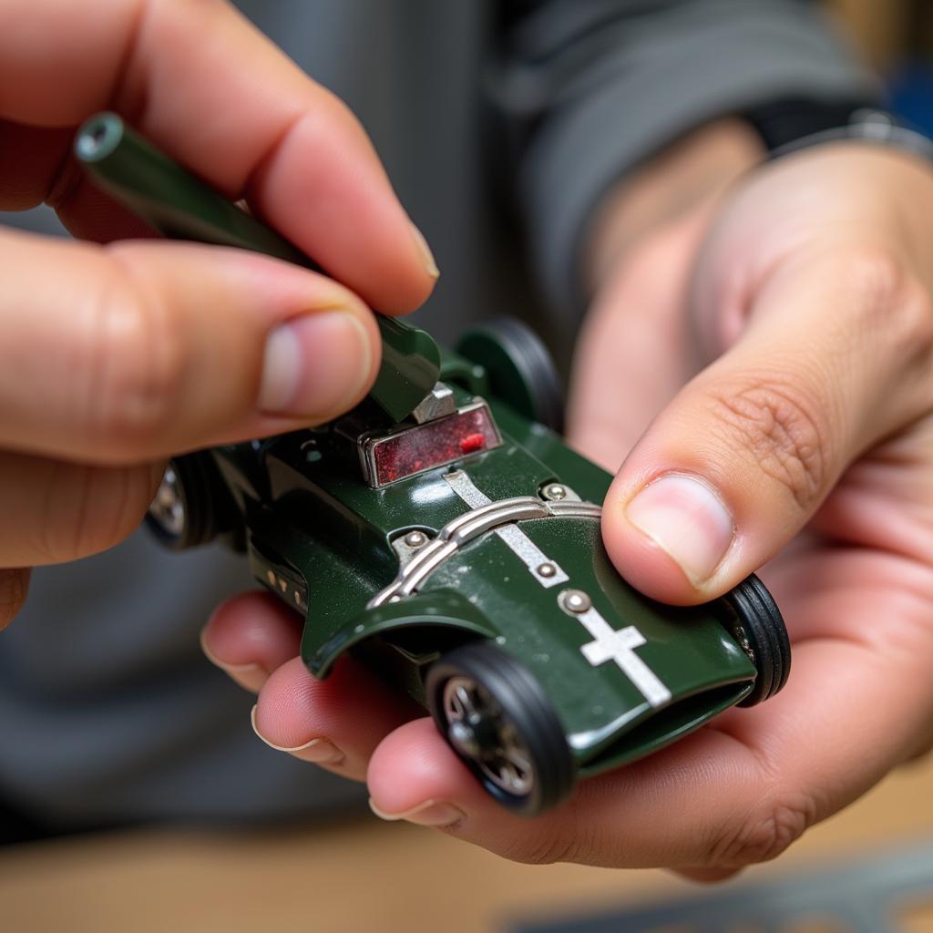 Slot car guide flag tool being used to adjust the guide flag on a slot car.